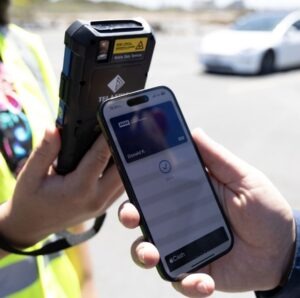 Mobile credential being scanned by handheld validator