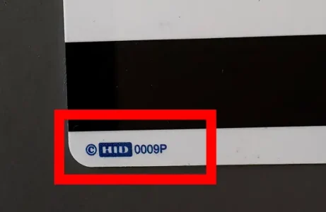 zoomed in corner of an HID security prox card showing the HID logo and "0009P"