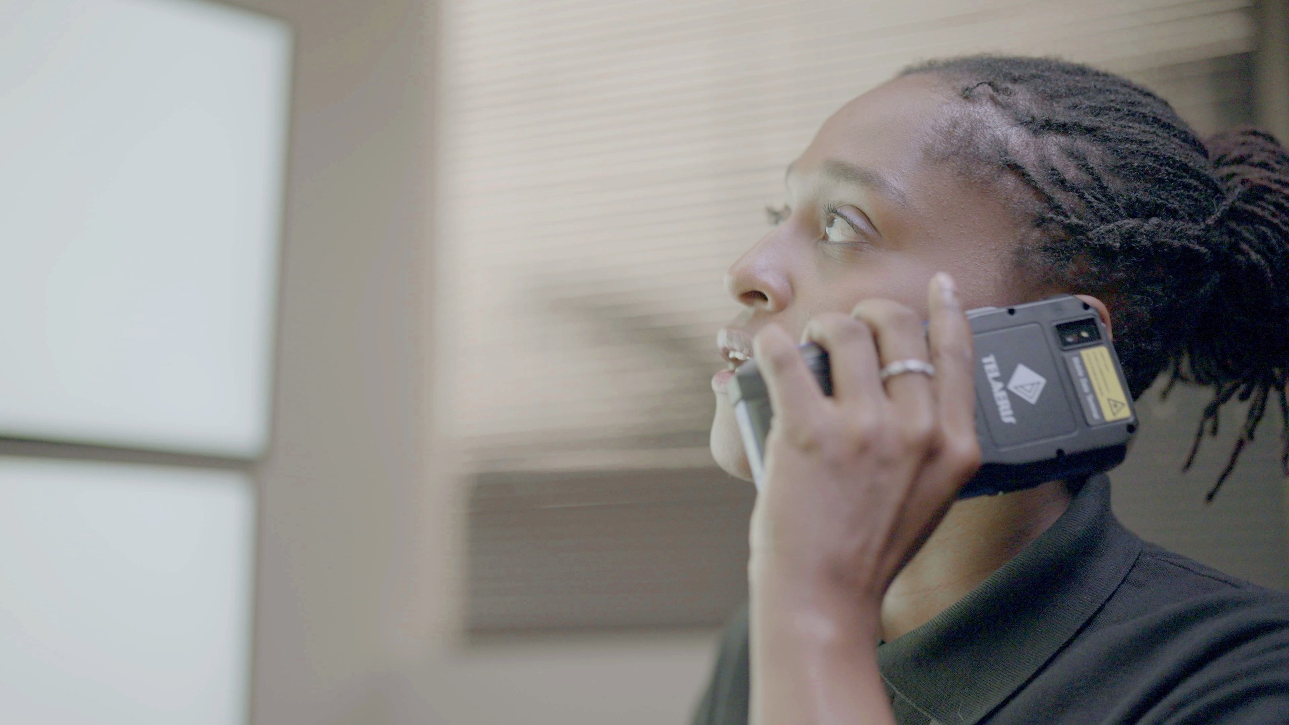 Security guard talking to the security office on an XPressEntry handheld with Push to Talk